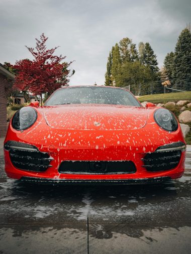 free-photo-of-a-modern-red-car-covered-in-foam