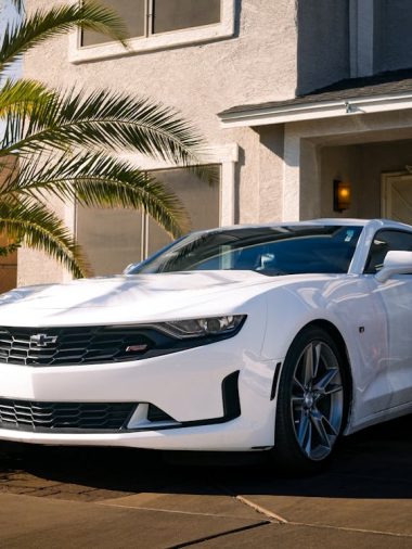 free-photo-of-sleek-white-sports-car-parked-in-residential-driveway